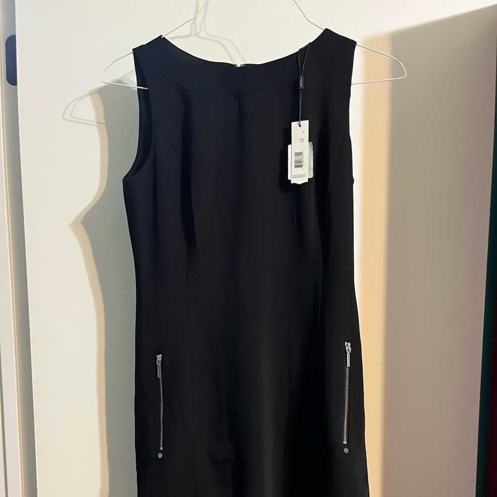 NWT Tahari black dress. Zipper pockets. Excellent condition.